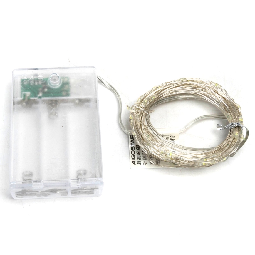 LED svetelný reťazec AIGOS TAP s batériovým zdrojom. Reťazec je zvinutý. Batériový box je priehľadný, obsahuje dve batérie.