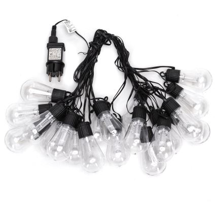 Svetelný reťaz s pätnástimi priehľadnými žiarovkami na čiernych kábloch a sieťovým adaptérom. Žiarovky sú spojené do reťazca. Adaptér je pripojený k reťazcu.