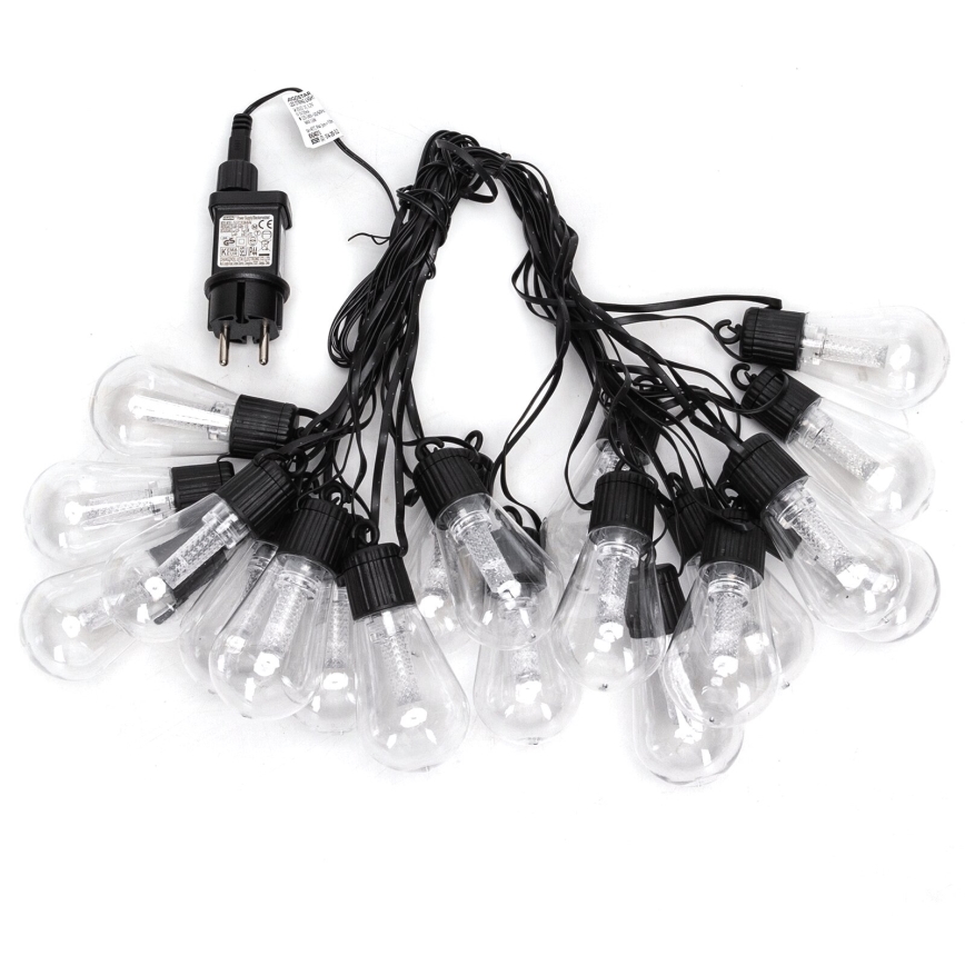 Svetelný reťaz s pätnástimi priehľadnými žiarovkami na čiernych kábloch a sieťovým adaptérom. Žiarovky sú spojené do reťazca. Adaptér je pripojený k reťazcu.