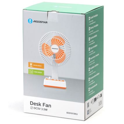 Stolový ventilátor s oranžovými lopatkami v kartónovej krabici. Ventilátor je biely a oranžový, má tri rýchlosti. Na krabici je uvedené: Desk Fan, DC5V 3.5W, B301013KU a viaceré jazykové verzie názvu stolový ventilátor.