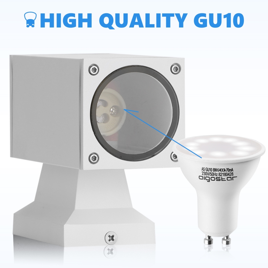 Biela LED dióda GU10 sa vkladá do štvorcového vonkajšieho svietidla. Svietidlo je biele a má podstavec. Text na dióde: A5 GU10 8W 6400K 70mA 230V/50Hz 82180428 aigostar. HIGH QUALITY GU10.