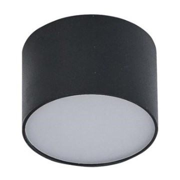 Svietidlo svieti na bielom pozadí. Je to valcovité, čierne svietidlo s bielym difúzorom.