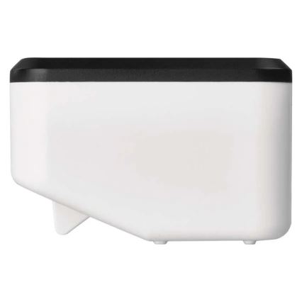 Biely plastový zásobník s čiernym vrchnákom stojí na bielom pozadí. Zásobník má zrezaný tvar a malé nožičky.