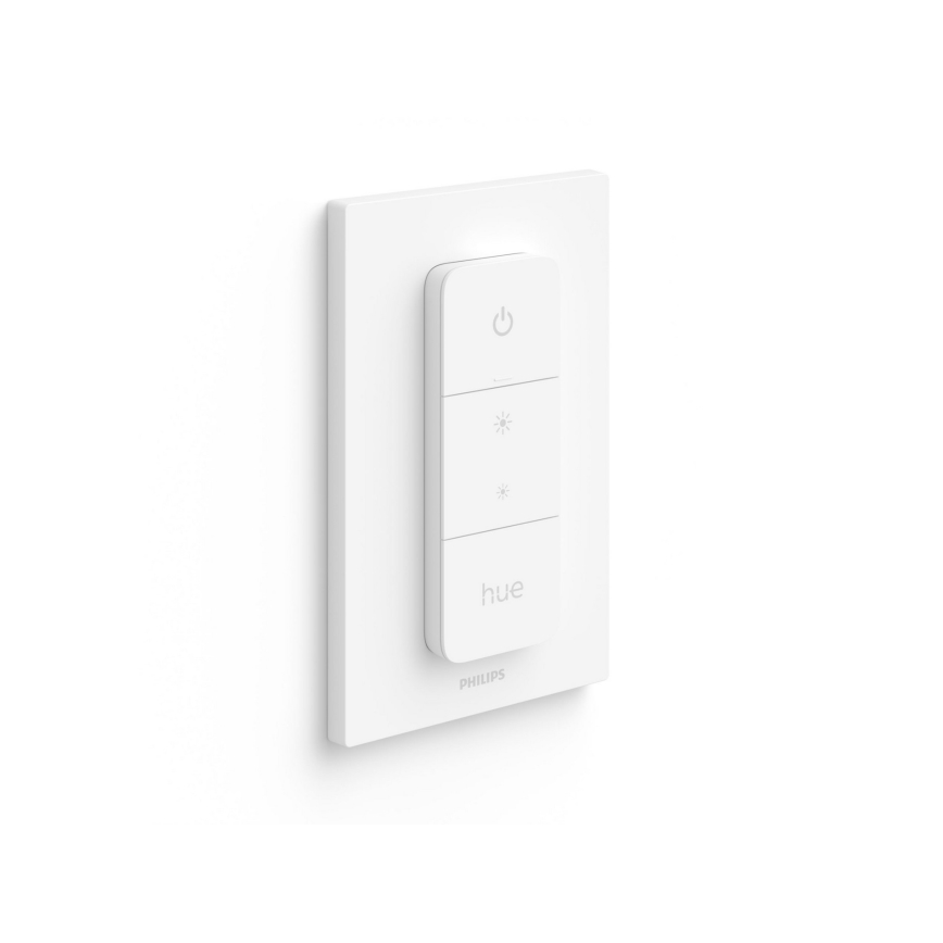 Biely stmievač Philips Hue je namontovaný na stene. Obsahuje tlačidlá pre zapnutie/vypnutie a reguláciu jasu. Na stmievači je nápis „hue“ a logo „PHILIPS“.
