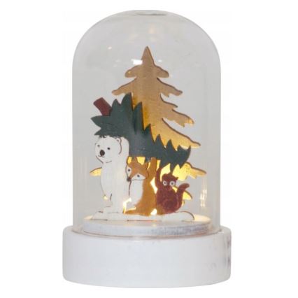 Svetlo s drevenými figúrkami medveďa, líšky a veveričky pod umelým stromčekom v sklenenej kupole na bielej podstavci. Svetlo je vnútri.