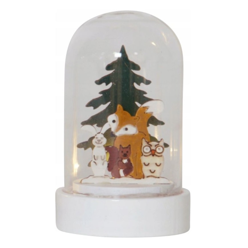 Svietiaca guľa zobrazuje skupinu lesných zvierat – líšku, zajaca, veveričku a sovu – stojacich pred vianočným stromčekom. Celok je umiestnený na bielom podstavci.