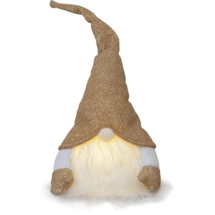 Svietiaci trpaslík s trblietkavým zlatým klobúkom a bielym fúzikom sedí na bielom pozadí. Jeho rukávy sú tiež trblietkavo zlaté. Svetlo vyžaruje z jeho tváre.