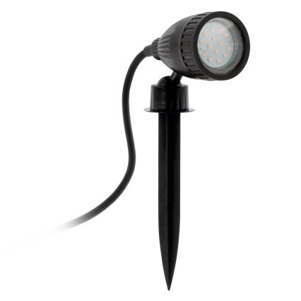 LED bodové svetlo s čiernym plastovým telom a kovovým hrotom je zapichnuté do zeme. Svetlo je pripojené k elektrickému káblu.