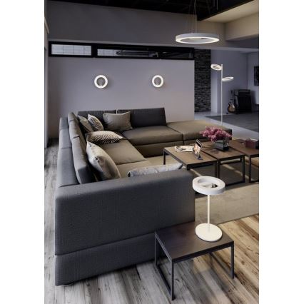 Rohová sedačka stojí v obývacej izbe. Na stole pri nej je umiestnená stolová lampa s kruhovým tienidlom. V miestnosti sú aj ďalšie kruhové svietidlá na stene a visiace zo stropu.