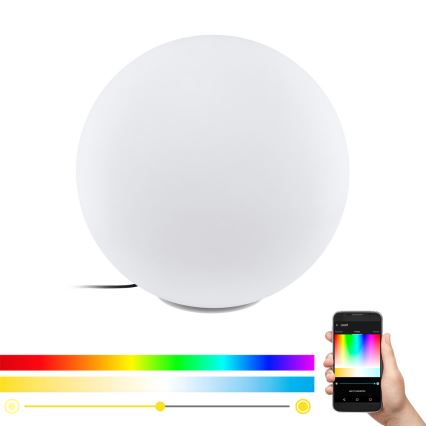 Guľová stolová lampa svieti. Lampa sa ovláda cez mobilnú aplikáciu, ktorá zobrazuje farebnú paletu a posuvníky pre nastavenie jasu a teploty svetla.