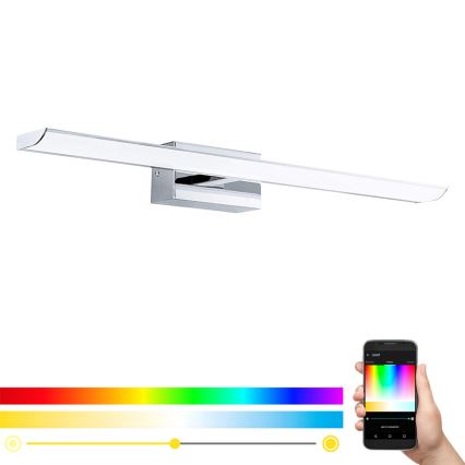 Dlhá chromovaná LED lampa svieti. Ovládanie farieb svetla je prostredníctvom mobilnej aplikácie zobrazeného smartfónu. Aplikácia zobrazuje farebnú paletu a posúvače nastavenia intenzity a teploty svetla.