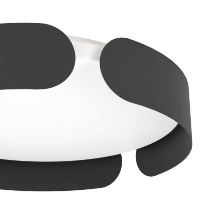 Svietidlo s bielym difúzorom je obklopené tmavosivými, organicky tvarovanými prvkami. Svietidlo je umiestnené v bielom pozadí.