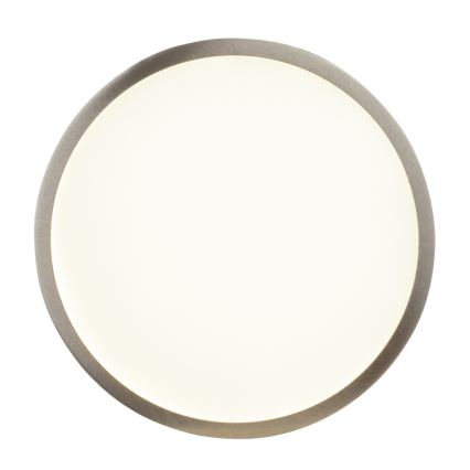 Okrúhle svietidlo svieti. Má svetlý stred a tmavosivý kovový rám. Je umiestnené na bielom pozadí.