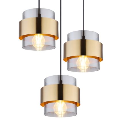 Tri závesné lampy visia zhora. Každá lampa má zlatý kovový pás a priehľadný sklenený valec s vnútornou žiarovkou. Lampa je zavesená na čiernom kábli na bielom pozadí.