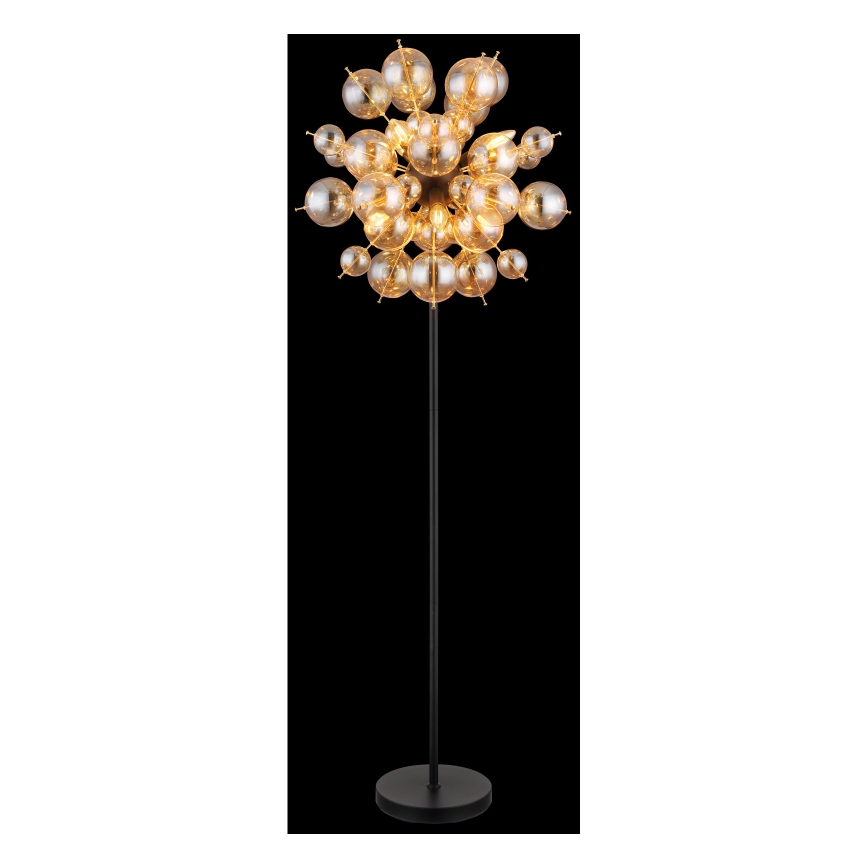 Stojacia lampa s vysokým čiernym stojanom a rozsiahlym tienidlom zloženým z mnohých malých, priesvitných sklenených guličiek jantárovej farby. Guličky sú pripevnené k centrálnemu bodu a vytvárajú rozvetvený tvar.