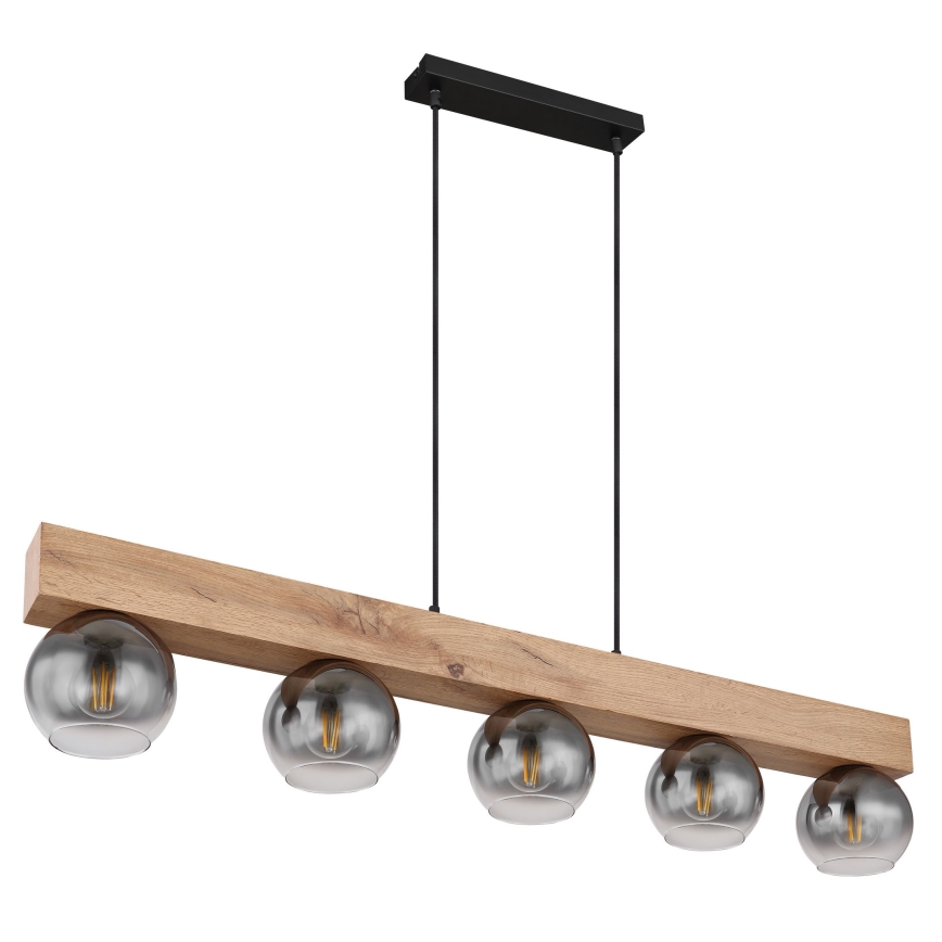 Drevená lampa s piatimi sklenenými tienidlami visí zo stropu. Tienidlá sú tmavosivé, s viditeľnými žiarovkami. Drevo je svetlé, nosná časť je pripevnená k čiernemu držiaku na strope.