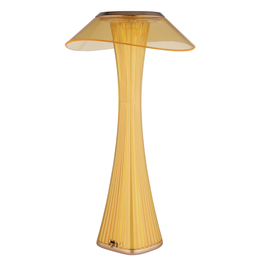 Stolová lampa so žltým tienidlom v tvare huby svieti. Jej telo je vysoké, úzke a rebrované. Stojí na bielom pozadí.