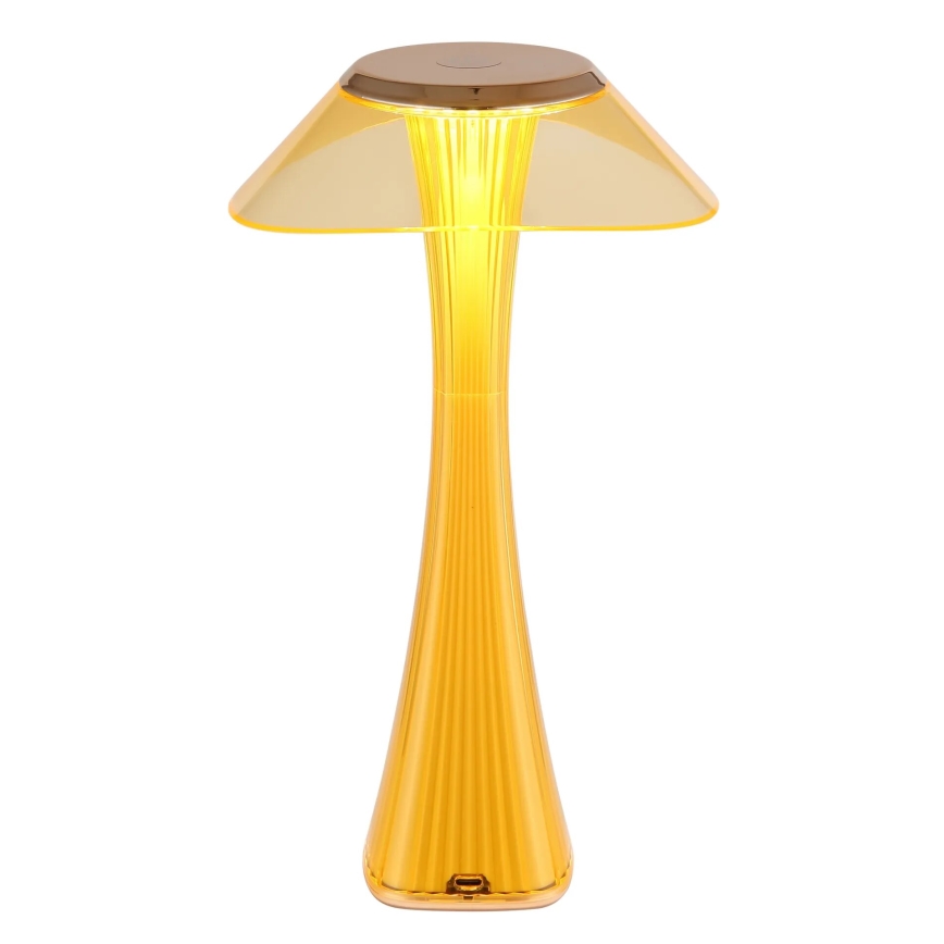 Žltá stolová lampa s tvarom huby svieti. Má široký, priesvitný tienidlo a vysoké, rebrované telo. Je umiestnená na bielom pozadí.