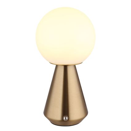 Stolová lampa svieti. Jej tienidlo je guľaté, mliečne biele. Podstavec je kužeľovitý, zlatohnedej farby. Na spodku podstavca sa nachádza vypínač.