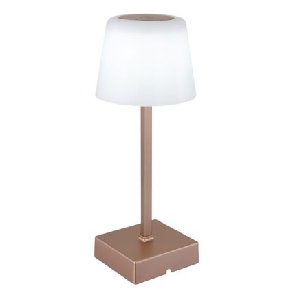 Stolová lampa s bielym tienidlom v tvare valca a ružovo-zlatou kovovou základňou a stĺpikom. Lampa stojí na štvorcovej podstave.