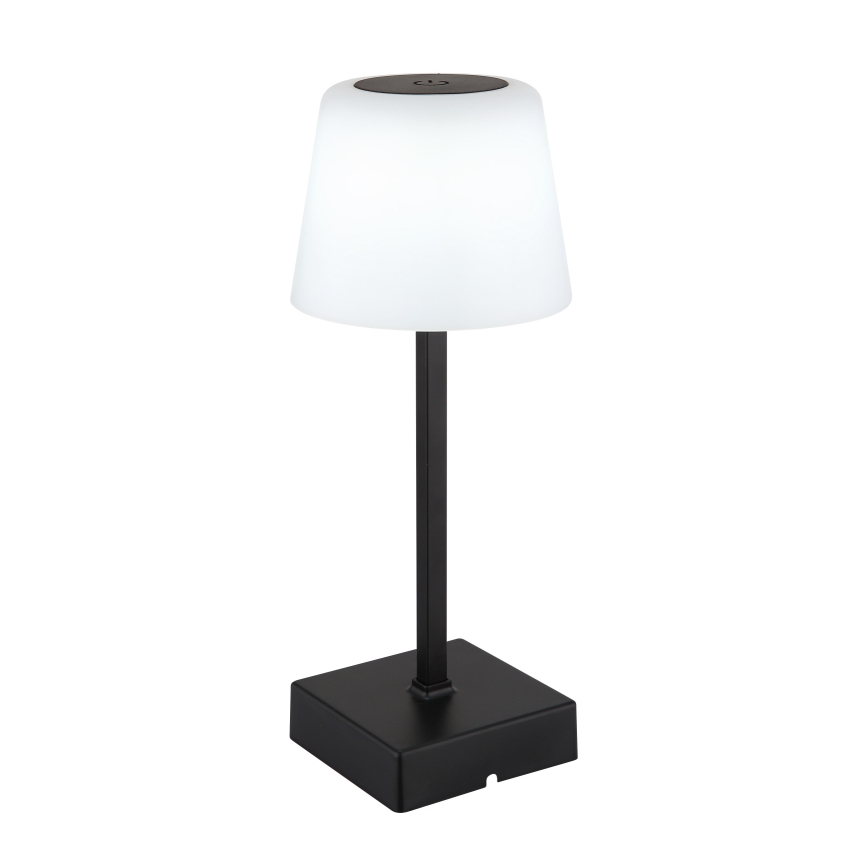 Stolová lampa s bielym tienidlom v tvare zrezaného kužeľa je umiestnená na štvorcovej čiernej základni. Tenká čierna tyč spája tienidlo a základňu. Na vrchu tienidla je malý čierny otvor.
