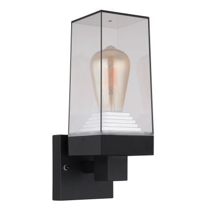 Nástenná lampa s čiernym rámom a čírym skleneným krytom, v ktorom je umiestnená žiarovka tvaru Edisonky. Lampa je pripevnená k stene.