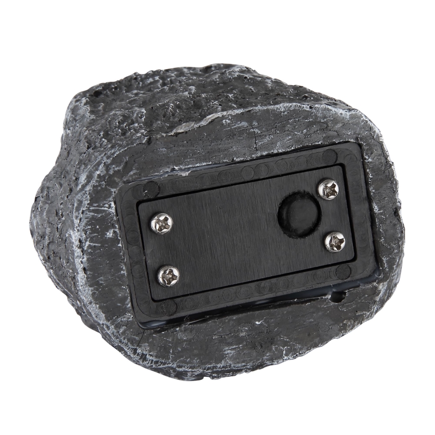 Kamenný dekoratívny predmet s imitáciou štruktúry kameňa má na spodnej strane čierny panel so spínačom a skrutkami. Panel je upevnený v dekoratívnom kameni.