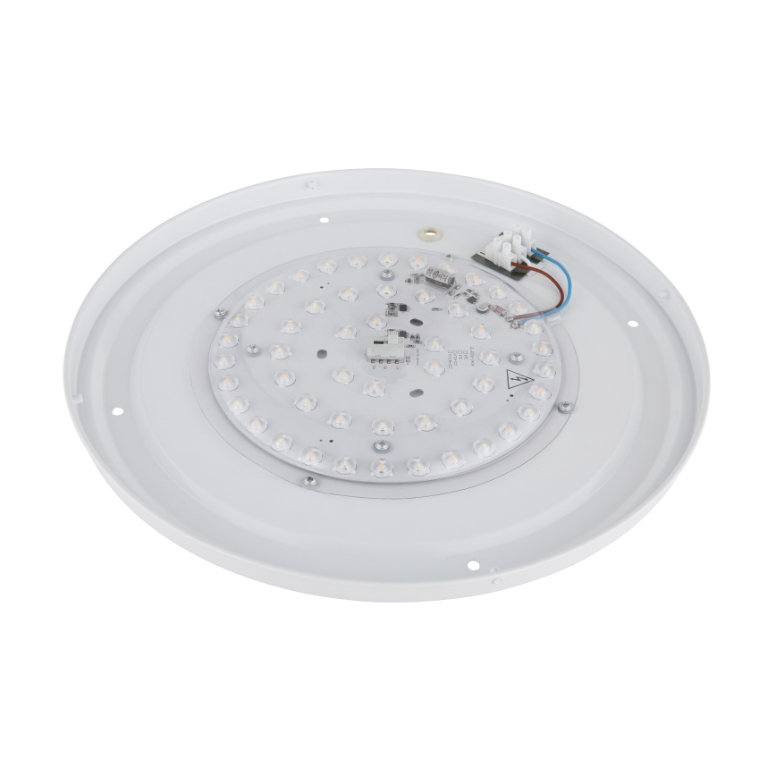 LED panel je zobrazený zhora. Panel obsahuje mnoho malých LED diód na doske s plošnými spojmi, pripojenými k elektrickým káblom. Panel je umiestnený na bielom, okrúhlom ráme.
