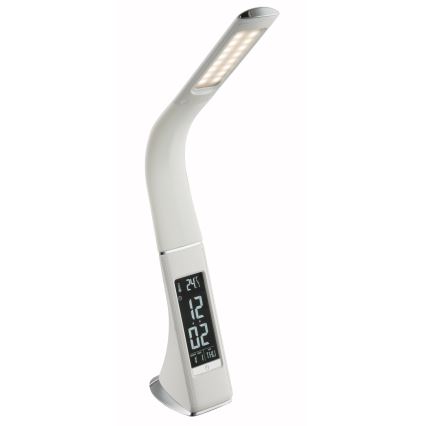 Biela stolová lampa s LED osvetlením svieti. Na spodnej časti je zabudovaný digitálny displej zobrazujúci čas 12:02, teplotu 24°C a deň v týždni (ŠTV). Lampa je umiestnená na bielom pozadí.