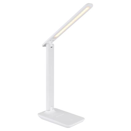 Biela stolová lampa s LED osvetlením svieti. Lampa je skladacia s dlhým, úzkym ramenom. Stojí na plochej, širokej základni.