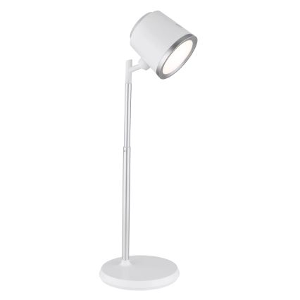 Biela stolná lampa s nastaviteľným ramenom a okrúhlou základňou svieti. Svietidlo je kovové, strieborno-biele.