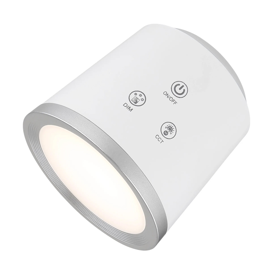 Valcovité LED svetlo svieti. Na jeho vrchu sú tlačidlá: ON/OFF, DIM, CCT. Svetlo je prevažne biele s strieborným lemom.