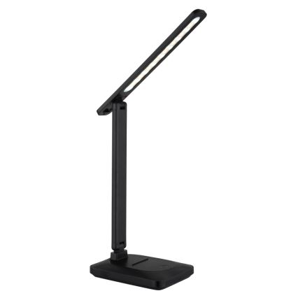 Stolná lampa s LED osvetlením svieti. Je čierna, skladacia a má štvorcovú základňu. Lampa je umiestnená na bielom pozadí.
