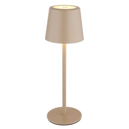 Stolová lampa s tlmeným svetlom, stojí na kruhovom podstavci, má vysokú štíhlu nohu a kužeľovitý tienidlo béžovej farby.