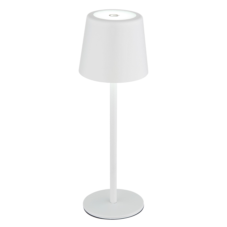 Biela stolová lampa s kužeľovitým tienidlom svieti. Má úzky stĺpik a okrúhlu základňu. Na tienidle je viditeľné malé tlačidlo.