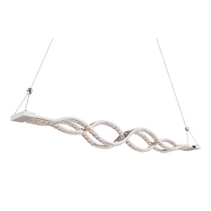 Dlhý, vlnitý luster s kryštálikmi visí zo stropu na dvoch tenkých kábloch. Svietidlo má biely rám a je zdobené krištáľovými kamienkami, ktoré sú vsadené do vlnitej štruktúry.