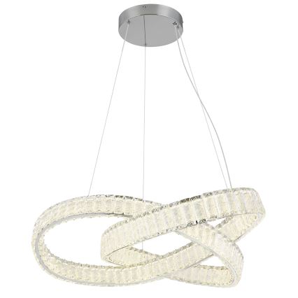 LED lustre svieti. Dva prepletené oválne kruhy z krištáľových prvkov sú zavesené na stropných lankách z kovovej stropnice.