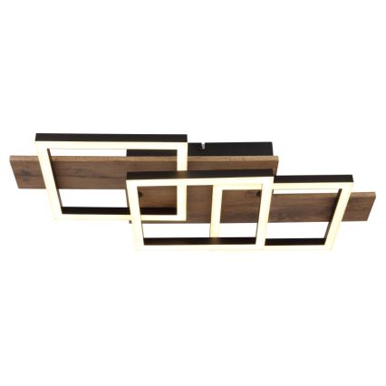 Svietidlo svieti. Skladá sa z prekrývajúcich sa štvorcových LED rámov z tmavého kovu a drevených lamiel. Je pripevnené k stropu.