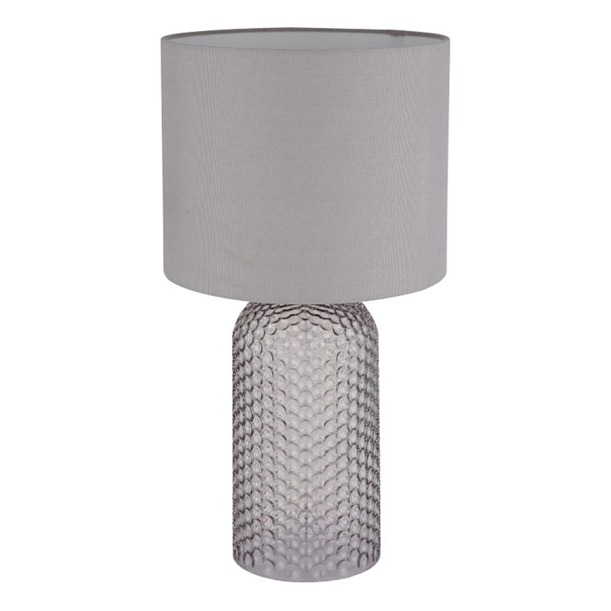 Stolová lampa s šedým textilným tienidlom stojí na podstavci z priehľadného, bublinkového skla. Lampa je umiestnená na bielom pozadí.