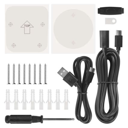 Sada na montáž obsahuje USB kábel, skrutky, hmoždinky, šablóny na označenie otvorov, skrutkovač a ďalšie drobné príslušenstvo na inštaláciu. Šablóny ukazujú označenie TOP.