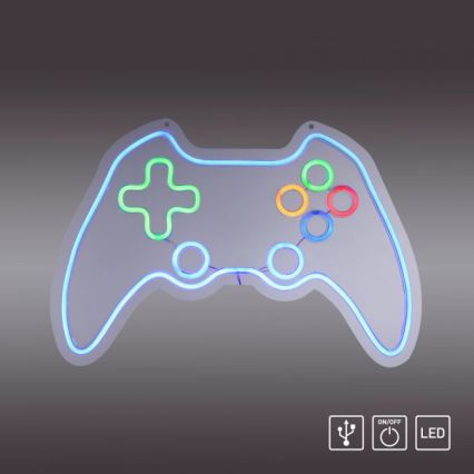 Neonové svetlo tvaru herného ovládača svieti. Svetlo je pripevnené na sivom pozadí. Symboly USB, vypínač a LED označujú zdroj energie a typ osvetlenia.