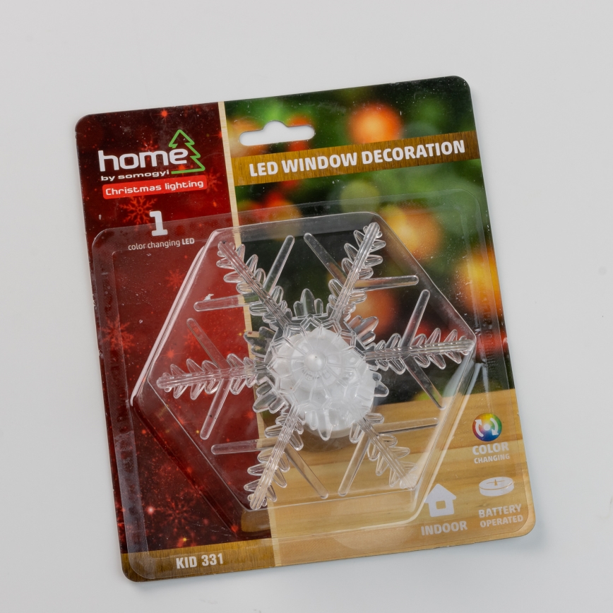 Svetlá svietiaca snehová vločka – LED vianočná výzdoba na okno. Balenie oznamuje 1 farebne meniace sa LED diódu, batériové napájanie a vnútorné použitie. Kód produktu: KID 331.