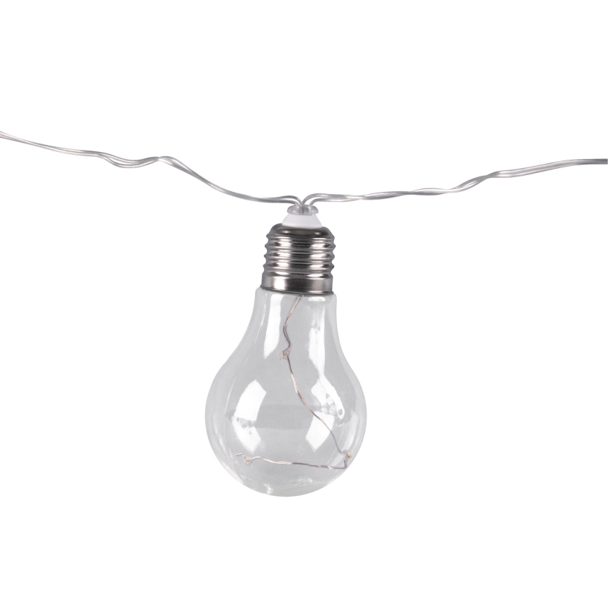 Svietiaca žiarovka z priehľadného skla visí na tenkom striebornom drôte. Vnútorné osvetlenie je viditeľné. Žiarovka je súčasťou girlandy.
