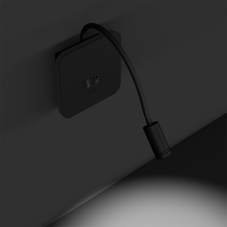 Dlhý čierny kuchynský ostrov s piatimi vysokými stoličkami stojí v modernej kuchyni s bielymi skrinkami a čiernymi spotrebičmi. Na ostrove je váza s ružami.