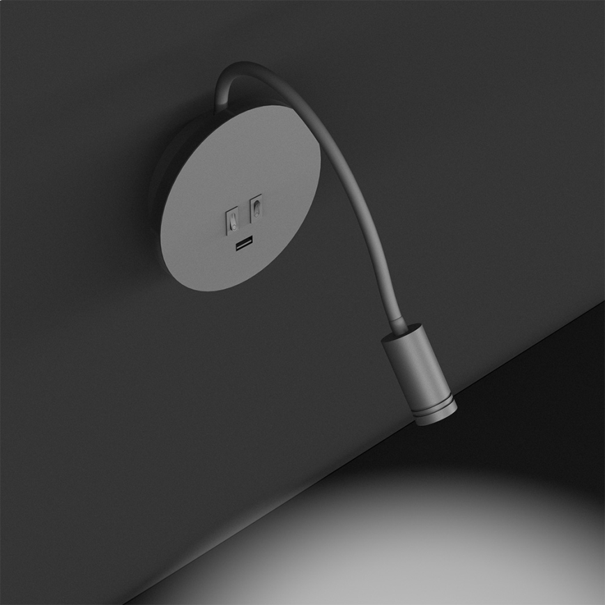 Čierna nástenná lampa s ohybným ramenom svieti. Na základni sú dva vypínače a USB port. Lampa je umiestnená na bielom pozadí.