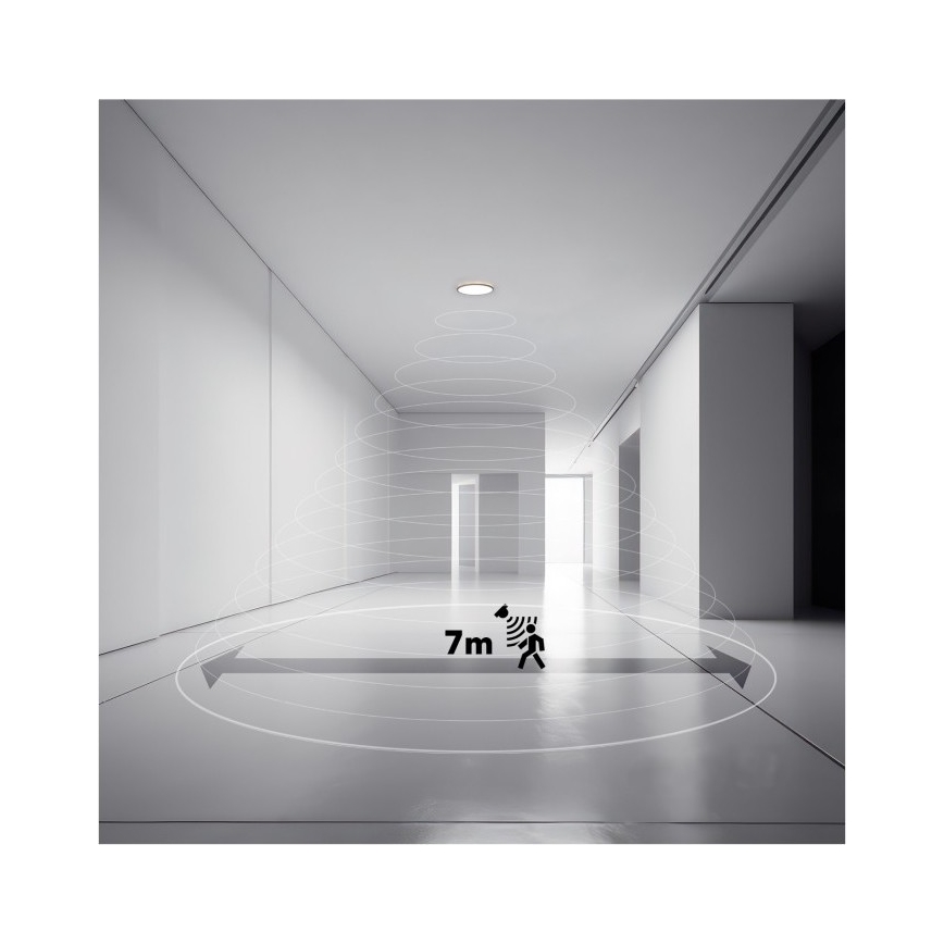 Svietidlo s pohybovým senzorom detekuje pohyb v priestore dlhej chodby. Dosah detekcie je 7 metrov. Chodba je svetlá, s bielymi stenami a dverami.