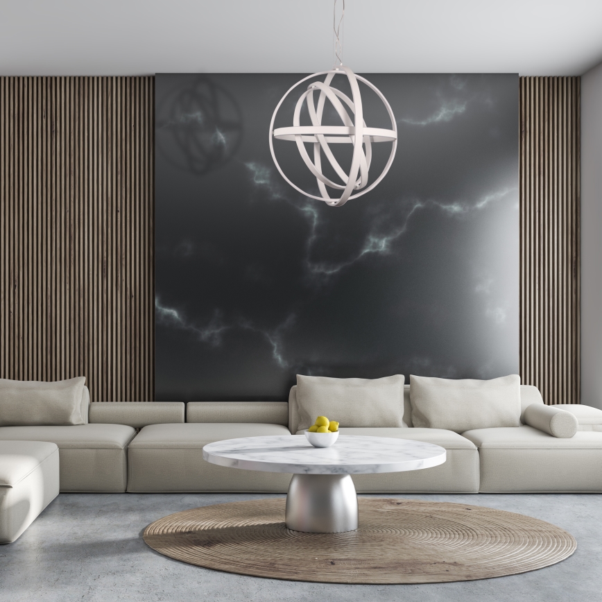 Svetlo svietiace v interiéri. Rohový gauč je umiestnený v miestnosti s drevenou podlahou, obrazom na stene a konferenčným stolíkom.