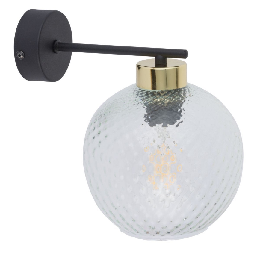 Nástenná lampa s guľovým tienidlom zo svetlozeleného, štruktúrovaného skla, čiernou kovovou konštrukciou a zlatým prstencom, je pripevnená na stenu. Lampa je osvetlená žiarovkou.
