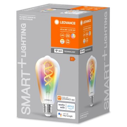 Balenie LED žiarovky zobrazuje farebnú žiarovku s vláknom v tvare špirály. Je inteligentná, kompatibilná s aplikáciou LEDVANCE, Alexou a Hey Google. Balenie udáva: Filament Edison 40, E27 Multicolor, 470 lm 360°, 4,8 W, E27.