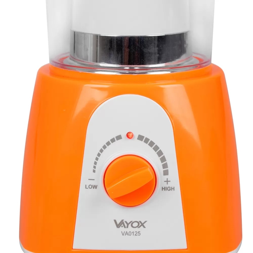 Pomarančový mixér s priehľadnou nádobou má otočný ovládač s nastavením nízkej a vysokej rýchlosti. Na ovládači svieti červená kontrolka. Na spodku je viditeľné logo Vayox a označenie VA0125.
